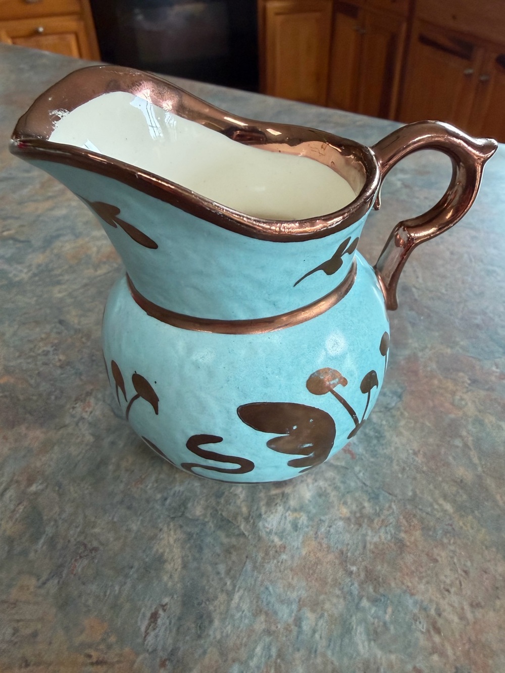 Abingdon turquoise cream pitcher with copper color accents. Good condition.